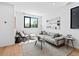 Bright and airy living room with modern decor, large windows, and hardwood floors at 1601 Park Ave # 212, Denver, CO 80218