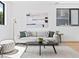 Bright living room with modern furniture, a stylish rug, and a large window at 1601 Park Ave # 212, Denver, CO 80218