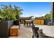 Inviting rooftop patio boasts an outdoor grilling station and dining space surrounded by lush greenery at 1601 Park Ave # 212, Denver, CO 80218