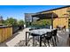 Stylish rooftop patio featuring a full outdoor kitchen and dining area with city views at 1601 Park Ave # 212, Denver, CO 80218