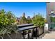 Enjoy city views from this rooftop patio with bar-top seating and green foliage at 1601 Park Ave # 212, Denver, CO 80218