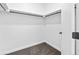 Spacious walk-in closet featuring a dark gray carpet and a convenient hanging rod for optimal storage at 1601 Park Ave # 212, Denver, CO 80218