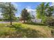 Spacious backyard with green lawn and a detached storage shed on a sunny day at 201 4Th St, Frederick, CO 80530