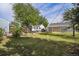 Fenced backyard featuring lush lawn, a trailer and car, and storage shed at 201 4Th St, Frederick, CO 80530