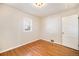 Bright bedroom features hardwood floors, fresh paint, and window for natural light at 201 4Th St, Frederick, CO 80530