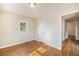 Bright bedroom with natural light, glossy hardwood floors, and convenient access to hallway at 201 4Th St, Frederick, CO 80530