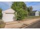 View of the garage, house, and backyard, all accessible from a concrete sidewalk at 201 4Th St, Frederick, CO 80530