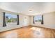 Bright living room with hardwood floors and multiple windows at 201 4Th St, Frederick, CO 80530