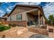 Inviting backyard with covered patio, built-in grill, and beautifully landscaped garden beds at 25144 E Archer Pl, Aurora, CO 80018