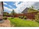 Lush green lawn in a private fenced backyard with mature trees and landscaping at 25144 E Archer Pl, Aurora, CO 80018