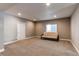 Large finished basement with carpet, futon, and natural light from a window at 25144 E Archer Pl, Aurora, CO 80018