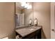 The half bathroom features a granite countertop, framed mirror, and cabinet at 25144 E Archer Pl, Aurora, CO 80018