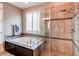 Beautiful bathroom featuring a soaking tub with tile surround and a glass-enclosed shower at 25144 E Archer Pl, Aurora, CO 80018