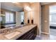Upscale bathroom with granite countertops, dual sinks, and a separate tub and glass-enclosed shower at 25144 E Archer Pl, Aurora, CO 80018
