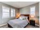 Cozy bedroom featuring a wooden bed frame, plush bedding, and two bedside tables with lamps at 25144 E Archer Pl, Aurora, CO 80018