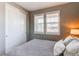 Comfortable bedroom with large windows, white shutters, and a spacious closet with sliding doors at 25144 E Archer Pl, Aurora, CO 80018