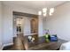 Bright dining room with wood floors, stylish light fixture, and laundry room conveniently located nearby at 25144 E Archer Pl, Aurora, CO 80018