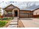 Charming home with a three-car garage and welcoming front porch at 25144 E Archer Pl, Aurora, CO 80018