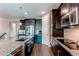 Modern kitchen boasting stainless steel appliances, granite countertops, and dark wood cabinets at 25144 E Archer Pl, Aurora, CO 80018