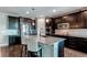 Stylish kitchen island featuring granite countertops, modern appliances, and pendant lighting at 25144 E Archer Pl, Aurora, CO 80018