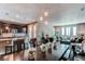 Inviting living space combining a dining area, kitchen, and living room with a cozy atmosphere at 25144 E Archer Pl, Aurora, CO 80018