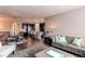 Spacious living room features comfortable seating, a plush rug, and ample natural light at 25144 E Archer Pl, Aurora, CO 80018