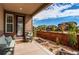 Cozy covered patio with outdoor seating overlooking the fenced yard and neighborhood views at 25144 E Archer Pl, Aurora, CO 80018