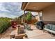 Spacious covered patio with comfortable seating and an outdoor grill, perfect for entertaining at 25144 E Archer Pl, Aurora, CO 80018