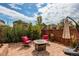 Outdoor stone patio with comfortable seating and a modern fire pit for cozy evenings at 25144 E Archer Pl, Aurora, CO 80018