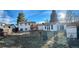 Spacious backyard with a charming two-story home and well-kept lawn at 9135 W Maplewood Ave, Littleton, CO 80123