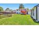 The spacious backyard features lush green grass and a red staircase leading to a deck at 9135 W Maplewood Ave, Littleton, CO 80123