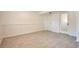 Basement living area featuring neutral paint, base-board trim, and tiled flooring at 9135 W Maplewood Ave, Littleton, CO 80123