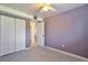 Bedroom with double door closet, window, and entry door with a staircase view at 9135 W Maplewood Ave, Littleton, CO 80123