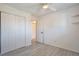Bedroom with light gray laminate flooring, ceiling fan, and a closet at 9135 W Maplewood Ave, Littleton, CO 80123