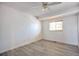 Bedroom with light gray laminate flooring, bright lighting, and a window at 9135 W Maplewood Ave, Littleton, CO 80123