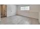 Spacious bedroom with tiled floors and a window at 9135 W Maplewood Ave, Littleton, CO 80123
