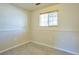 Bedroom featuring baseboard trim, window, and tiled floor at 9135 W Maplewood Ave, Littleton, CO 80123