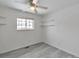 Bright bedroom features a ceiling fan, natural light from the window, and floating shelves at 9135 W Maplewood Ave, Littleton, CO 80123