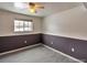 A cozy room with gray wainscoting and tile flooring, plus a ceiling fan at 9135 W Maplewood Ave, Littleton, CO 80123