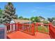 An outdoor deck offers views of the backyard, shed, and mature trees at 9135 W Maplewood Ave, Littleton, CO 80123