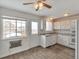 Bright kitchen featuring white cabinets, granite countertops, and a window with views at 9135 W Maplewood Ave, Littleton, CO 80123