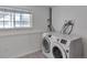 A well-lit laundry room featuring modern washer and dryer at 9135 W Maplewood Ave, Littleton, CO 80123