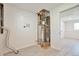 Laundry area with water heater and washer/dryer hookups adjacent to open room at 9135 W Maplewood Ave, Littleton, CO 80123