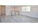Bright living room featuring light gray laminate flooring and staircase with metal railing at 9135 W Maplewood Ave, Littleton, CO 80123