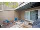 Back patio features outdoor seating, string lights, sliding glass door and basement access at 8095 E Colorado Ave # 5, Denver, CO 80231