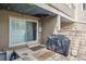 Inviting back patio with covered grill area, providing a perfect spot for outdoor entertaining and cooking at 8095 E Colorado Ave # 5, Denver, CO 80231