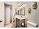 This bathroom has a vanity with light gray cabinets and floral decorations at 8095 E Colorado Ave # 5, Denver, CO 80231