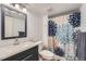 This bathroom has vanity with navy cabinets and shower/tub combo at 8095 E Colorado Ave # 5, Denver, CO 80231