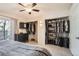 Bright bedroom featuring closet with multiple storage shelves and a sliding glass door at 8095 E Colorado Ave # 5, Denver, CO 80231