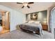Bright bedroom featuring a sliding glass door, ceiling fan, and closet at 8095 E Colorado Ave # 5, Denver, CO 80231